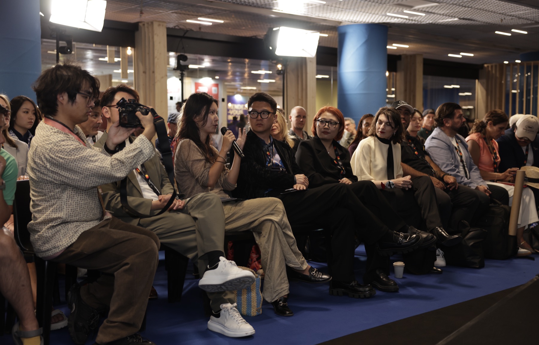 Audience members asking questions after the panel presentations